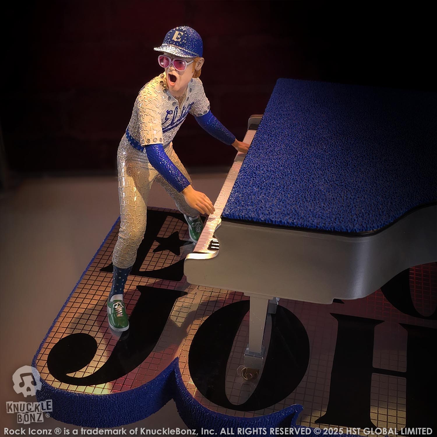 Statue of Elton John with a grand piano in a baseball uniform with a red background